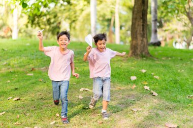 Uçak kağıt parkta oynarken küçük kardeş çocuk