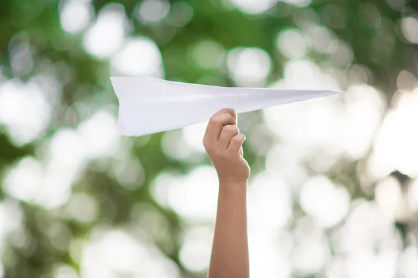 Mano de niño tomando papel de avión en el parque —  Fotos de Stock