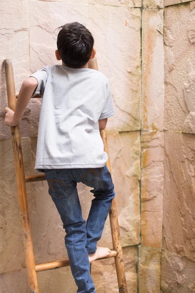 Little boy climbing up on ladder — Stock Photo, Image