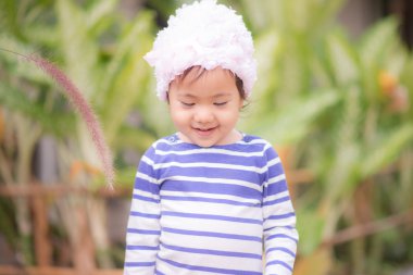 Çimen çiçek dokunmadan küçük şirin Asyalı kız