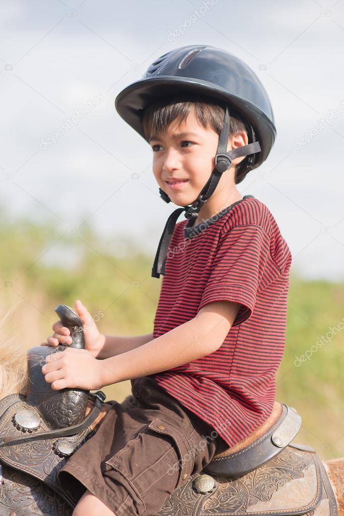Little boy riding horse