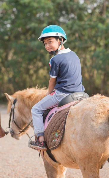 Little boy ridning utbildning häst — Stockfoto