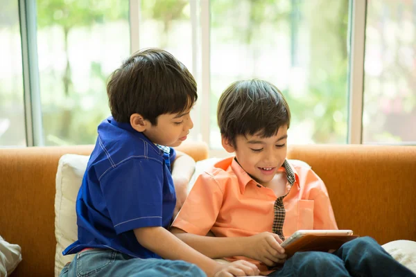Little sibling boy playing game on mobile together in house  living room — Stock Photo, Image