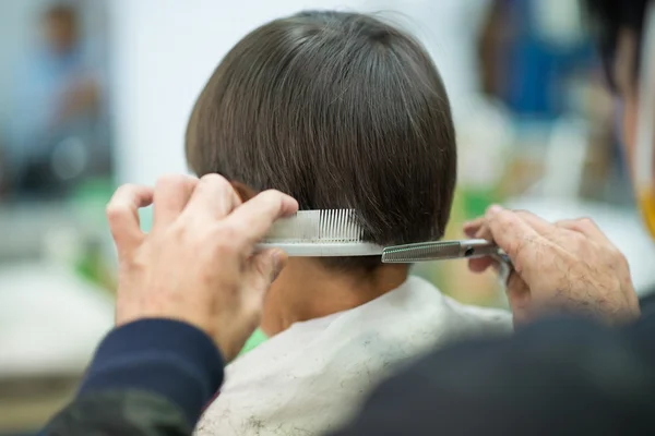 Little boy sitting for hair cut at barber shop — Stock Photo, Image