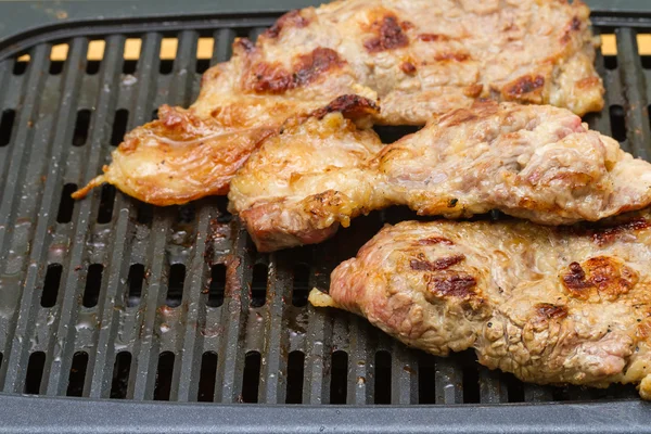 Steak meat grilling on electric barbecue grill — Stock Photo, Image