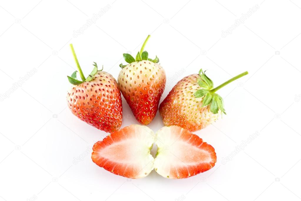 Strawberries with two halves of sliced section over white background