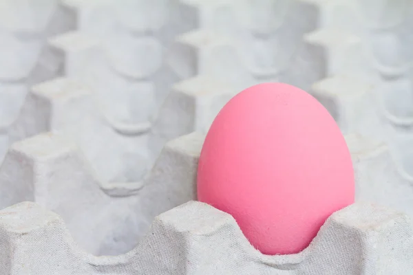 Pink preserved egg in paper package — Stock Photo, Image