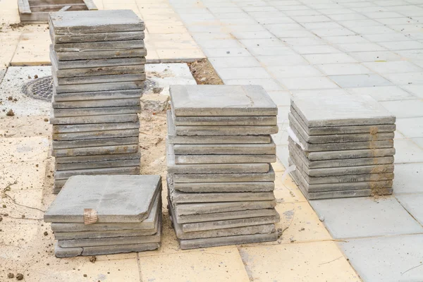 Stack of cement floor tiles at road side construction site — Stock Photo, Image