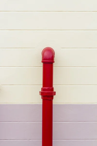 Red industrial pipe on the wall — Stock Photo, Image