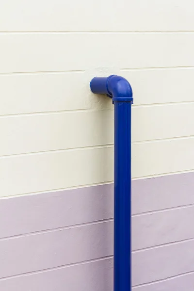 Синяя промышленная труба на стене — стоковое фото