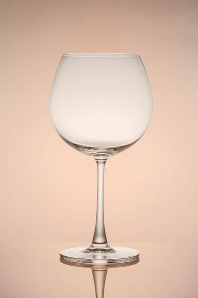 Empty wine glass isolated on brown background — Stock Photo, Image