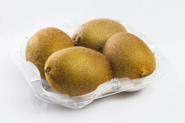 Container of kiwi fruits on white — Stock Photo, Image