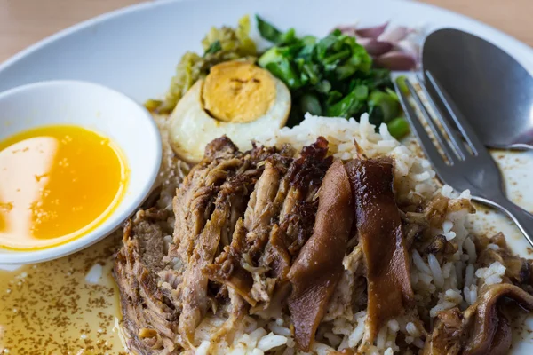 Stewed pork leg on rice with garlic — Stock Photo, Image