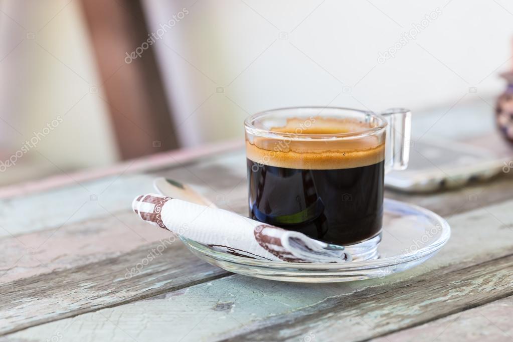 Hot cup of Coffee on an old wooden table