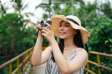 Klasik fotoğraf makinesi olan Asyalı genç bir kadının moda portresi. Resimdeki güzel fotoğrafçı.. 
