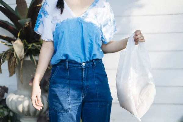 Cropped Image Girl Tie Dye Jeans Hold Plastic Bag — Stock Photo, Image