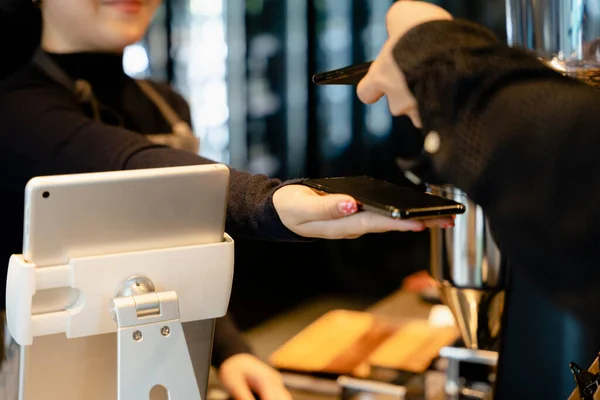 Customer paying food cost with QR code scanner in smartphone.