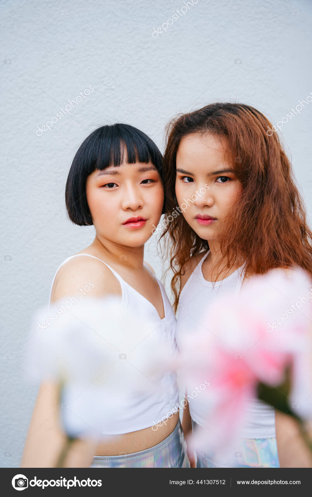 Portrait Two Young Asian Women Wear White Vest Holding Flowers Stock Photo by ©theshots.contributor@gmail 441307512 image