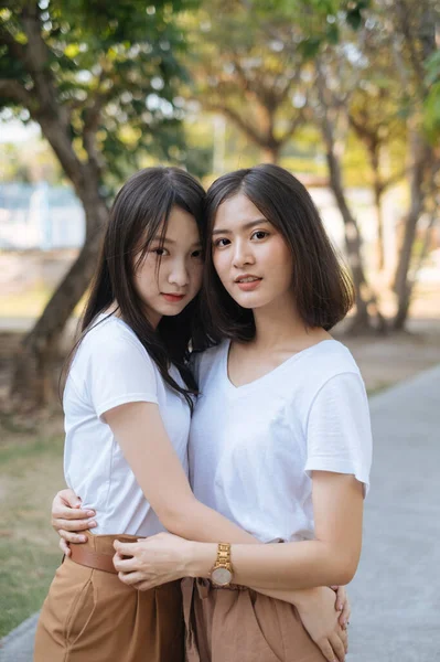 Medium Shot Two Girls White Shirt Brown Pants Standing Hug — Stock Photo, Image