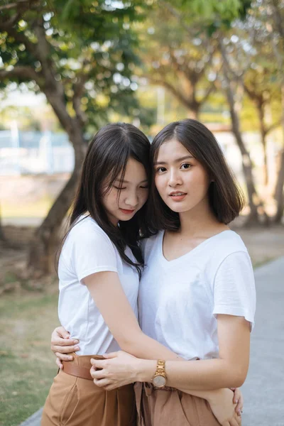 Medium Shot Two Girls White Shirt Brown Pants Standing Hug — Stock Photo, Image