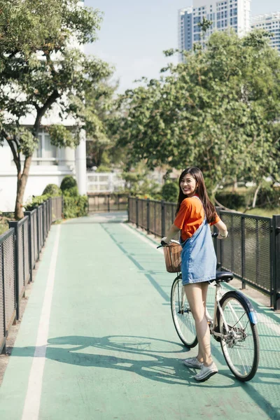 Long Hair Girl Orange Shirt Jeans Jumper Walk Her Bike — Stock Photo, Image