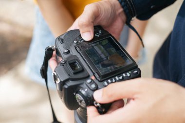 Fotoğrafçı ve model çektikleri fotoğrafa bakarken kesilmiş kamera görüntüleri..