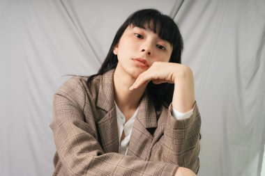 Güzel Asyalı Taylandlı, uzun siyah saçlı, ceketli kadın. Moda portresi. İş kadını.