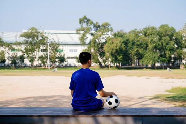 Boy Sitting Wooden Bench His Football Looking Field Stock Picture