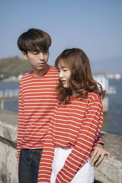 Couple Red Matching Shirt Stand Dam Guy Hold His Boyfriend Stock Photo