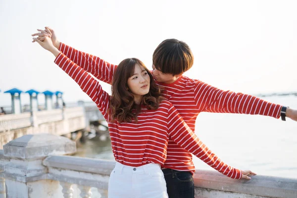 Young Couple Red Matching Shirt Posing Being Titanic While Standing Stock Picture