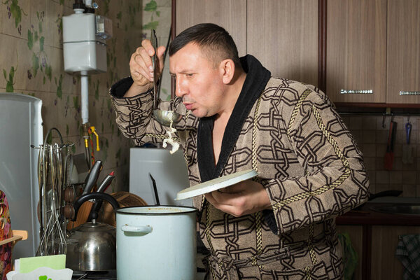 The member of household tries(tastes) soup from vegetarian products. Uses the recipe of a useful vegetable dish.