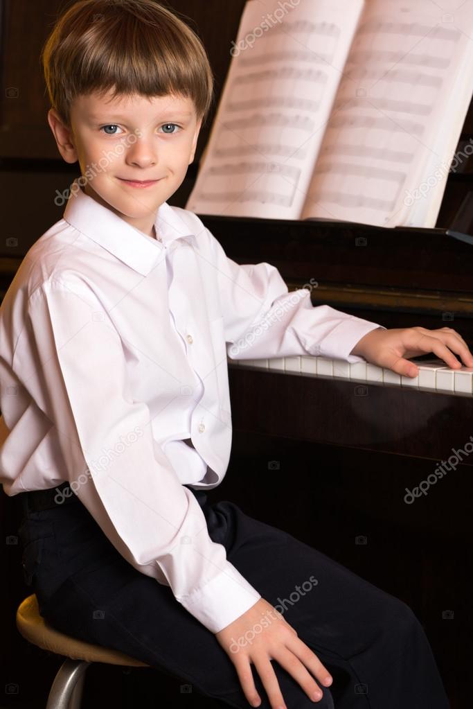 Boy piano. Piano player.