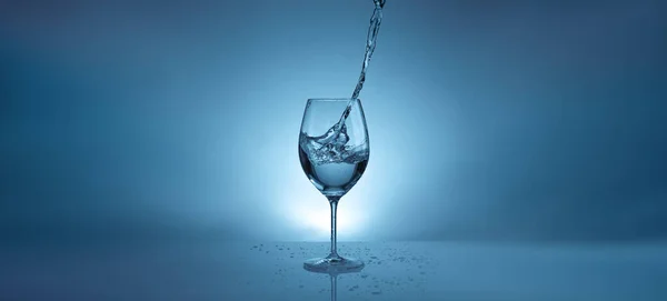 Banner Pouring Water Transparent Glass Wine Light Blue Background Water — Stock Photo, Image