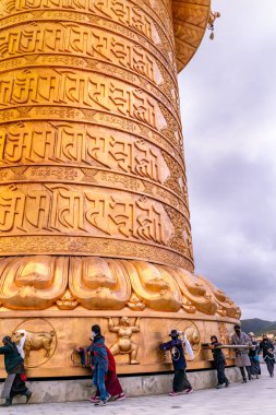 The big golden rolling prayer drum in the tibetan buddhist monastery clipart