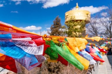 The amazing view of traditional buddhist flags in the Guihua monastery in Shangri-La in China clipart