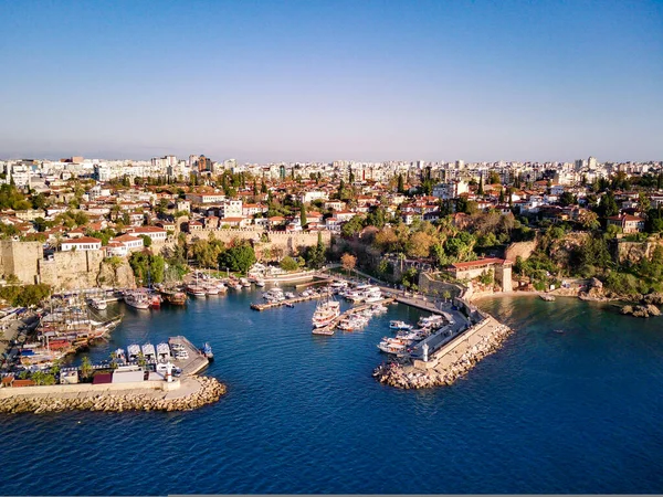 Aerial photograph of Antalya bay in Antalya city from high point of drone fly on sunny day in in Turkey. Amazing aerial cityscape view from birds fly altitude on beautiful town and sea full of yahts