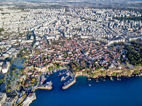 Aerial photograph of Antalya bay in Antalya city from high point of drone fly on sunny day in in Turkey. Amazing aerial cityscape view from birds fly altitude on beautiful town and sea full of yahts