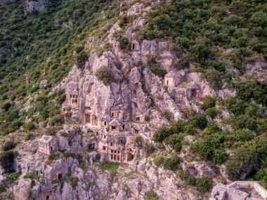 Antik Yunan kayalarının yüksek açılı insansız hava aracı görüntüsü Myra 'daki Lykian İmparatorluğu amfi tiyatro ve mezarlarını kesti (Demre, Türkiye)
