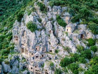 Antik Yunan kayalarının yüksek açılı insansız hava aracı görüntüsü Myra 'daki Lykian İmparatorluğu amfi tiyatro ve mezarlarını kesti (Demre, Türkiye)