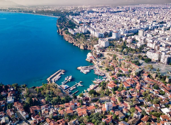 Aerial photograph of Antalya bay in Antalya city from high point of drone fly on sunny day in in Turkey. Amazing aerial cityscape view from birds fly altitude on beautiful town and sea full of yahts