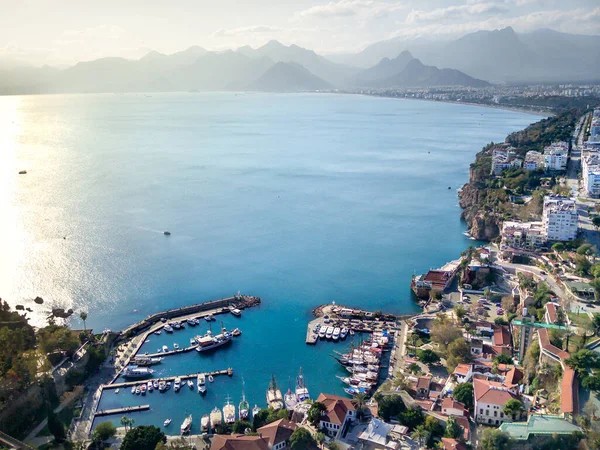 Aerial photograph of Antalya bay in Antalya city from high point of drone fly on sunny day in in Turkey. Amazing aerial cityscape view from birds fly altitude on beautiful town and sea full of yahts