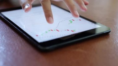 Yatırımcılar hisse senedi ticareti yapıyor. Akıllı telefonlar ve bilgisayarlar kullanarak