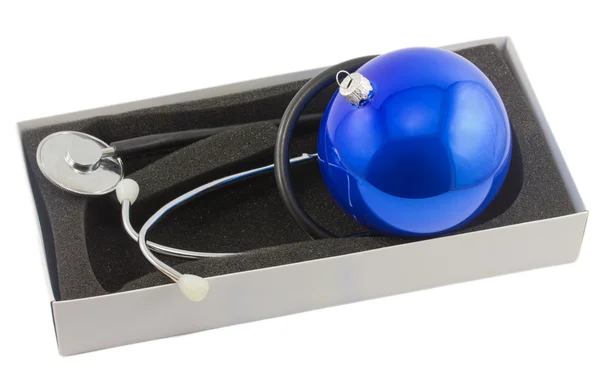 Phonendoscope and Christmas ball in box isolated on white backgr — Stock Photo, Image