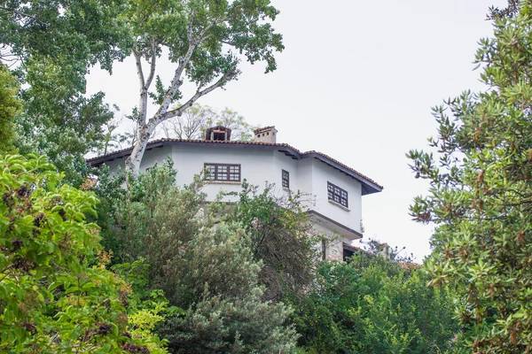 Casa branca com tampa de azulejo na colina — Fotografia de Stock