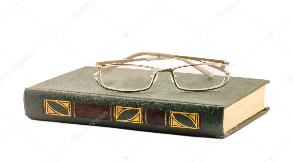 book and glasses isolated on white background