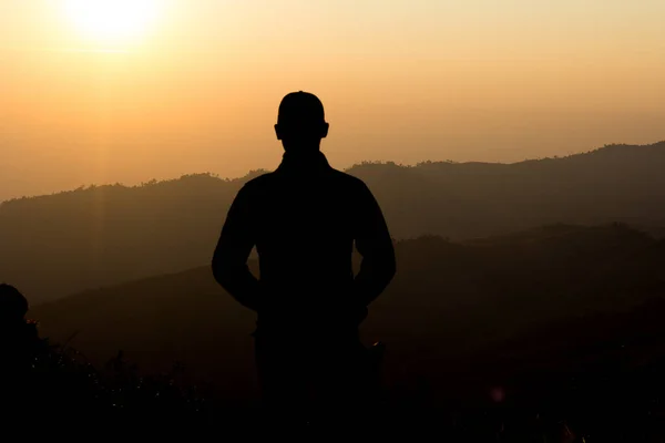 man silhouette Who were standing and watching the sunrise in the morning.