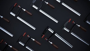 Siyah arka planda klemp var. 3D görüntüleme. Marangozluk aletleri