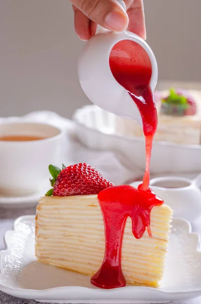 Pouring Strawberry Sauce Delicious Crepe Cake White Plate — Stock Photo, Image