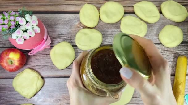 A woman puts jam on the dough. — Stock Video