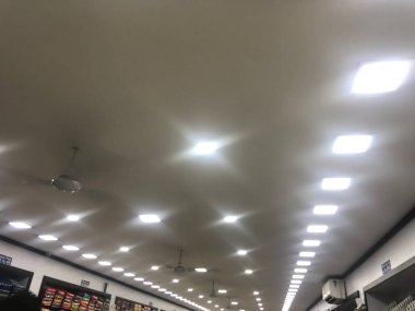 Gypsum false ceiling design with White LED lighting for an textile shop commercial clipart